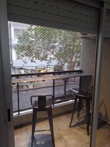 a view of a balcony with a table and a chair at Alquiler Temporario Rosario 4 in Rosario