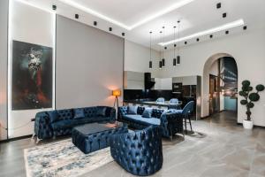 a living room with blue couches and a table at VIP APARTMENT FRANCE EMBASSY in Baku