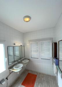 a bathroom with two sinks and two mirrors at logis la marine in Sidi Ifni +29 photos