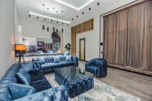 a living room with blue couches and a table at VIP APARTMENT FRANCE EMBASSY in Baku
