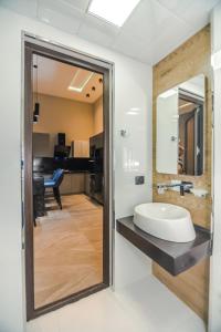 a bathroom with a sink and a mirror at VIP APARTMENT FRANCE EMBASSY in Baku