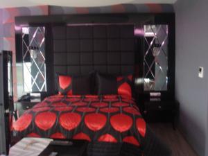 a bedroom with a red bed with red pillows at Golden Palas Hotel in Cerkezkoy