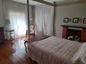 1 dormitorio con 1 cama, 1 silla y 1 ventana en Cascina Ciosse B&B, en Grognardo