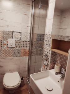 a bathroom with a toilet and a sink at La Maison apartment Puglia in Molfetta +22 photos