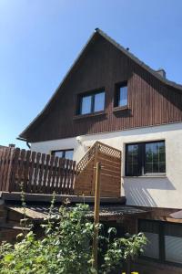 a house with a wooden fence in front of it at Ferienhaus Rupnow Plau am See in Plau am See