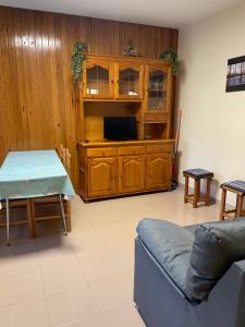 a living room with a couch and a table and a tv at Casa Miranda in Campo