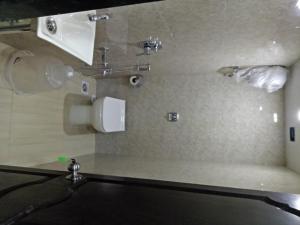 a bathroom with a sink and a mirror at Royal Dormitory in Mumbai