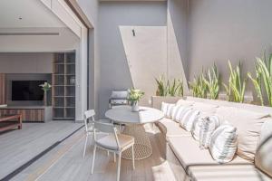 a living room with a couch and a table and chairs at Amazing Cabo Marina condo with private jacuzzi in Cabo San Lucas +3 photos