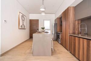 a kitchen with a island in the middle of a room at Amazing Cabo Marina condo with private jacuzzi in Cabo San Lucas