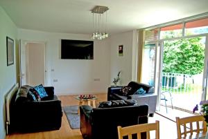 a living room with two couches and a table at Donard Holidays in Newcastle