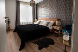 Postel nebo postele na pokoji v ubytování Cesar Apartman
