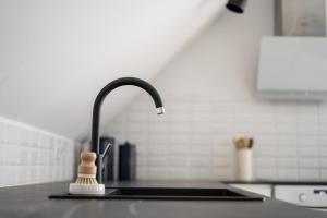a kitchen counter with a sink with a faucet at Cesar Apartman in Sopron