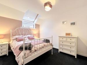 a bedroom with a bed and two night stands at Maries Hoose in Stornoway