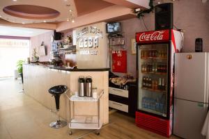 a cocacola soda machine in a kitchen with a bar at Hotel Deva in Sandanski