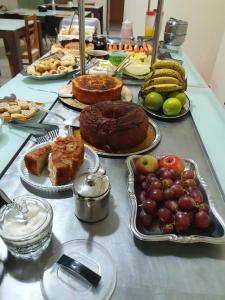 a table topped with lots of different types of food at Hotel Parati 