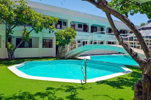 an image of a swimming pool in front of a building at Sunio City in Tijuana