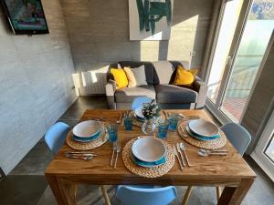 a dining room table with chairs and a couch at Prime Loft ANDORRA in Pas de la Casa