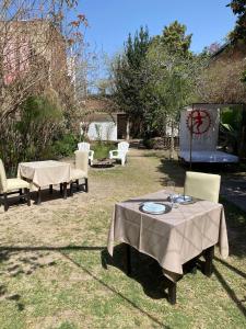 a group of tables and chairs in a yard at Samsara Hotel Salta in Salta