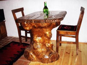 a wooden table with a wine bottle on top of it at Konaci Zaovljanska jezera in Zaovine