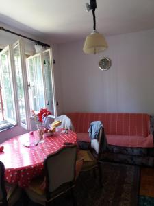 - un salon avec un canapé rouge et une table dans l'établissement Kuća sa apartmanom, à Sarajevo