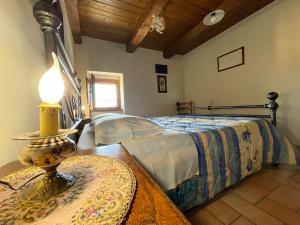 a bedroom with a bed and a lamp on a table at Agriturismo Le Castellare in Montemonaco