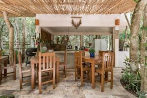 a kitchen and dining room with a table and chairs at Cachito de Cielo Luxury Jungle Lodge in Tulum