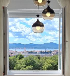 a window with a view of a city at Apartment "50 Shades" with balcony and free parking in the garage in Zadar