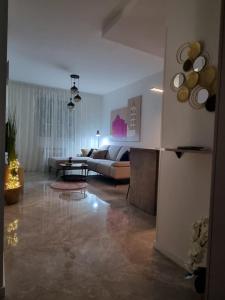 uma sala de estar com um sofá e uma mesa em Apartment "50 Shades" with balcony and free parking in the garage em Zadar