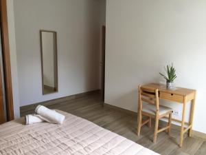 a bedroom with a bed and a table and a mirror at Calheta Ocean View Apartments 1 in Estreito da Calheta