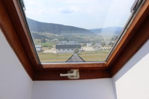 uma janela com vista para uma cidade e para as montanhas em Vila Ana em Travnik