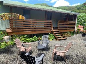 a group of chairs sitting in front of a house at APPARTEMENT MILO 1 in Bouillante