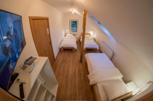a small room with three beds and a staircase at Petlov salaš rooms in Novi Sad