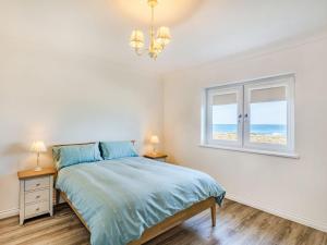 a bedroom with a bed and a window at Headland View in Banff