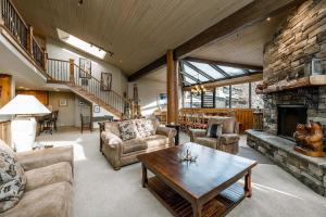 a living room filled with furniture and a stone fireplace at Silver King in Park City