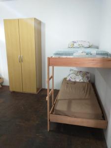 a bedroom with a bunk bed and a cabinet at Hostel Cachoeira in Porto Alegre