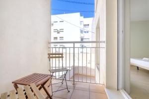 a balcony with a bench and a chair at Apartamentos La Rosita Old Town in Benidorm