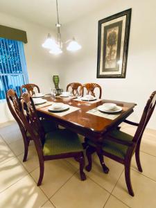 a dining room with a wooden table and chairs at Huge Screened Patio That Overlooks Lake Buck, Near Famous Attractions!! in Orlando