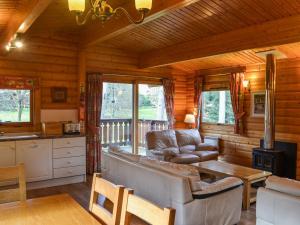 a living room with a couch and a table at Cosy Lodge - Uk37418 in Legbourne