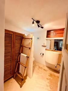 a bathroom with a towel ladder and a sink at Dos Ceibas Tulum Feel Good Hotel in Tulum