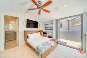 a bedroom with a bed and a ceiling fan at Beach House Steps from Balboa Ferry in Newport Beach