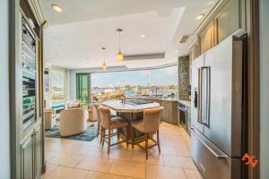 a kitchen with a table and a dining room with a view at Beach House Steps from Balboa Ferry in Newport Beach