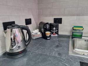 a kitchen counter with a tea kettle and a sink at Il Piccolo Sogno di Roma in Rome