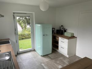 a kitchen with a blue refrigerator and a counter at Hofberg Villa in Landshut