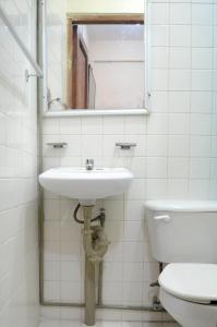 a bathroom with a sink and a toilet at Hotel Rosa del Alba in Chetumal