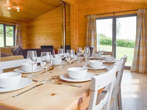 a dining room with a table with wine glasses at The Lodge in Great Easton