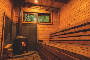 a room with a fireplace in a wooden cabin at Peuma Lodge Patagonia in Futaleufú