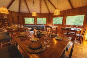 a dining room with a large wooden table and chairs at Peuma Lodge Patagonia in Futaleufú