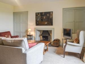 a living room with a couch and a fireplace at East Monkton Farm Cottage in Wick