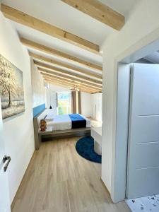 a bedroom with a bed and a large window at Blue Moon Guesthouse in Kamenicë