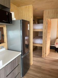 a kitchen with a refrigerator and a bunk bed at Quadro Matanzas cabañas in Matanzas